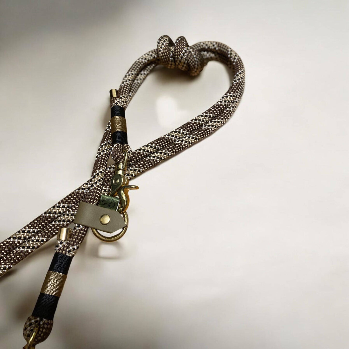 Close-up of Greenwich Yarn handsfree dog lead featuring chestnut rope, black and tan nano binding, and durable hardware.