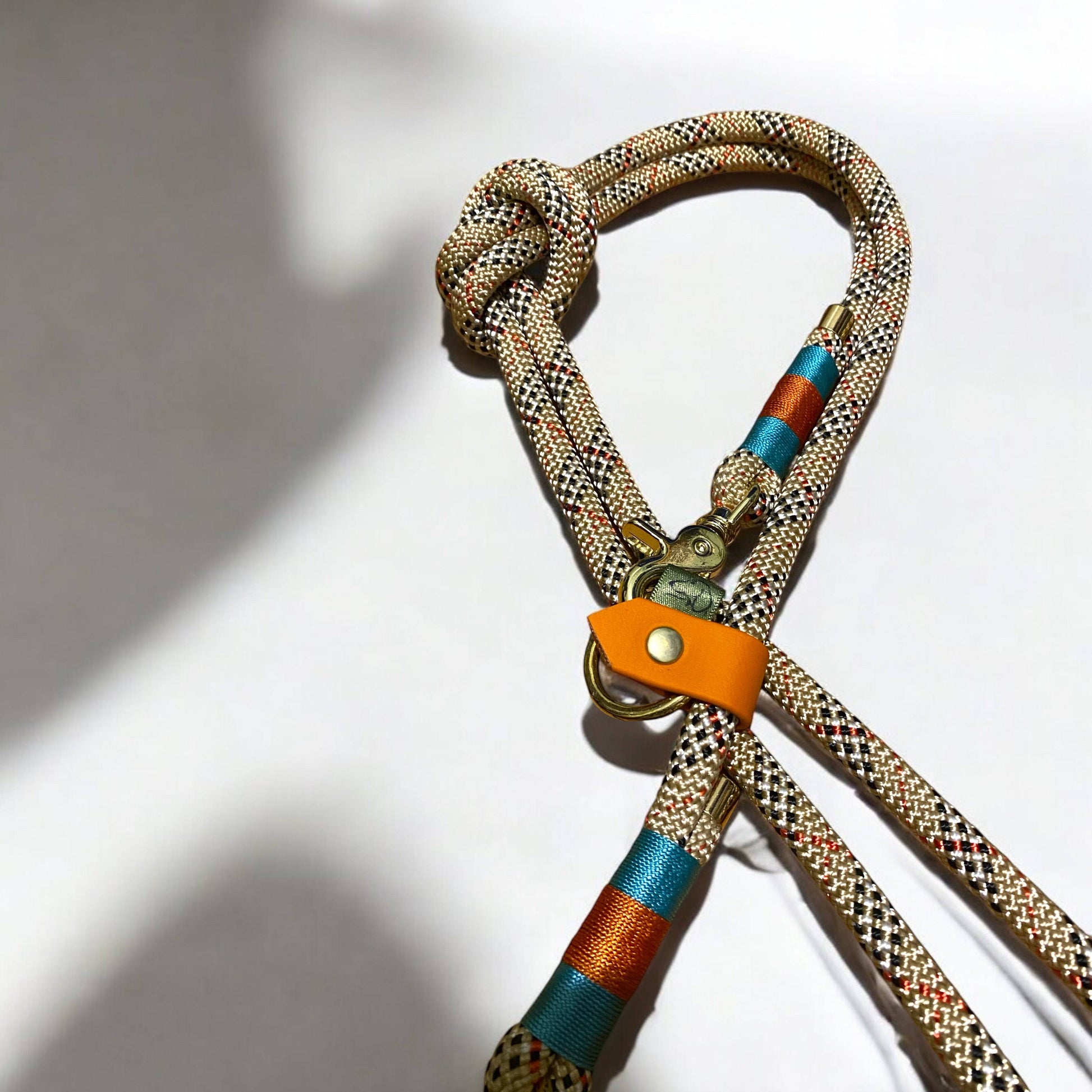 Close-up of Greenwich Yarn handsfree dog lead featuring tartan rope, Carolina blue and burnt orange nano binding, and durable hardware.
